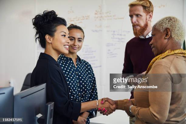 group of people at a start up business having a project meeting - greeting stock pictures, royalty-free photos & images