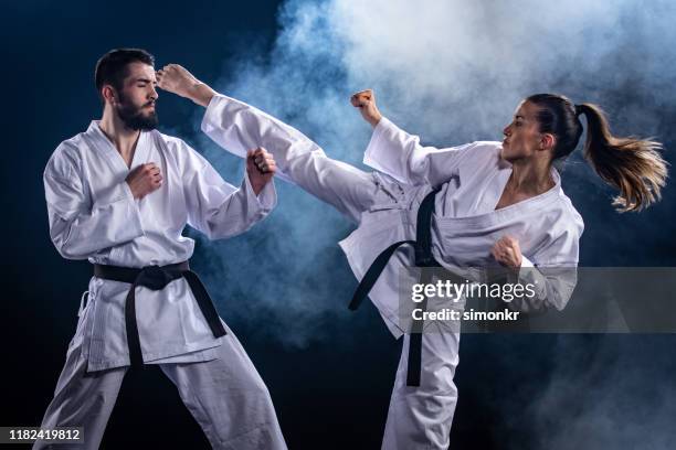 karate players competing during the match - karate imagens e fotografias de stock