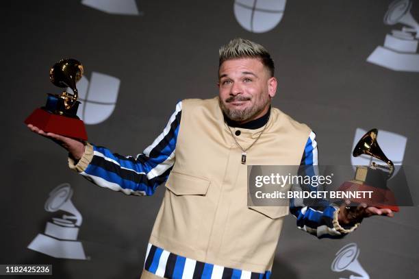 Puerto Rican singer Pedro Capo poses in the press room with the awards for "Best Song of the Year" and "Urban/Fusion Performance" during the 20th...