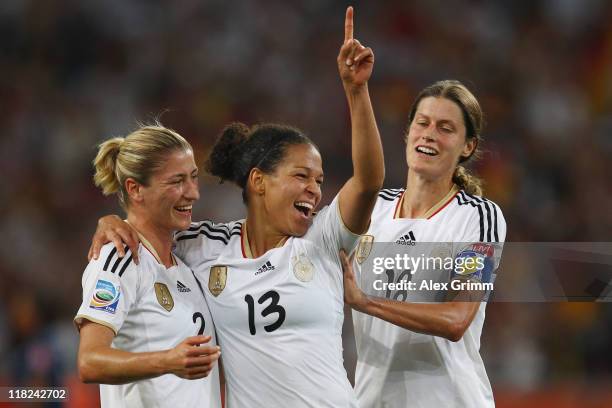 Celia Okoyino da Mbabi of Germany celebrates her team's fourth goal with team mates Bianca Schmidt and Kerstin Garefrekes during the FIFA Women's...