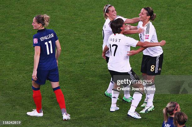 Inka Grings of Germany celebrates with her team mates after scoring her team's third goal during the FIFA Women's World Cup 2011 Group A match...