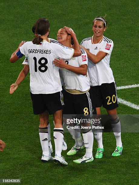 Inka Grings of Germany celebrates with her team mates after scoring her team's third goal during the FIFA Women's World Cup 2011 Group A match...