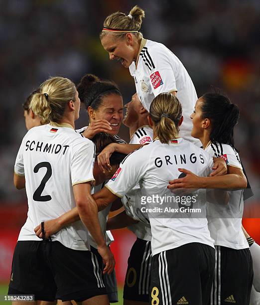 Celia Okoyino da Mbabi of Germany celebrates her team's fourth goal with team mates during the FIFA Women's World Cup 2011 Group A match between...