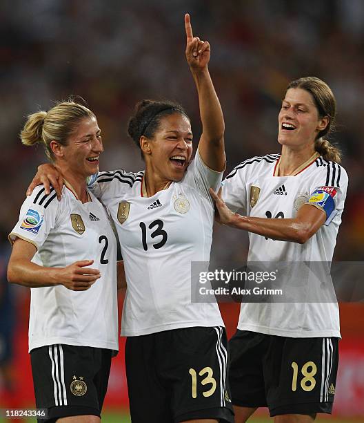 Celia Okoyino da Mbabi of Germany celebrates her team's fourth goal with team mates Bianca Schmidt and Kerstin Garefrekes during the FIFA Women's...