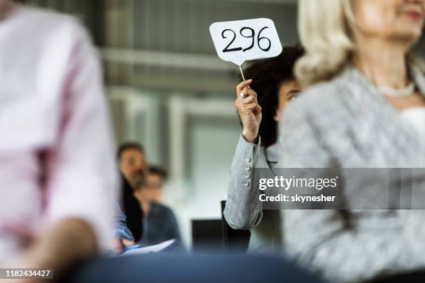 business auction in board room! - auction paddle stock pictures, royalty-free photos & images