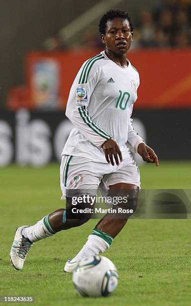 Rita Chikwelu of Nigeria runs with the ball during the FIFA Women's World Cup 2011 Group A match between Canada and Nigeria at Rudolf-Harbig-Stadion...