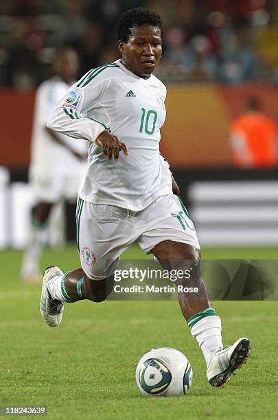 Rita Chikwelu of Nigeria runs with the ball during the FIFA Women's World Cup 2011 Group A match between Canada and Nigeria at Rudolf-Harbig-Stadion...