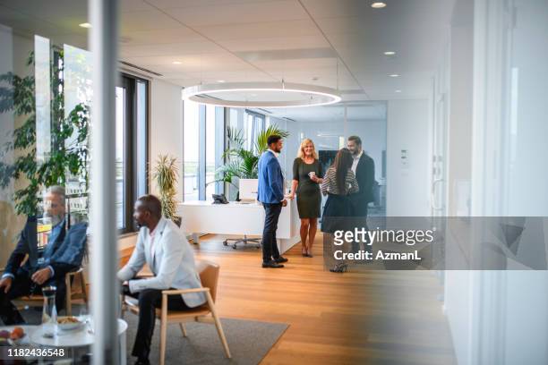 conversation groups on break from corporate business seminar - business relationship stock pictures, royalty-free photos & images