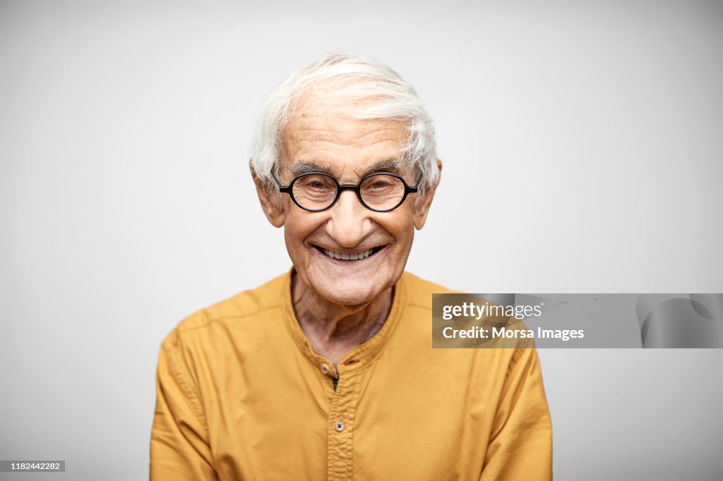 Portrait of smiling senior man having white hair