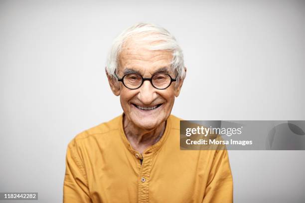 portrait of smiling senior man having white hair - senior man stock pictures, royalty-free photos & images