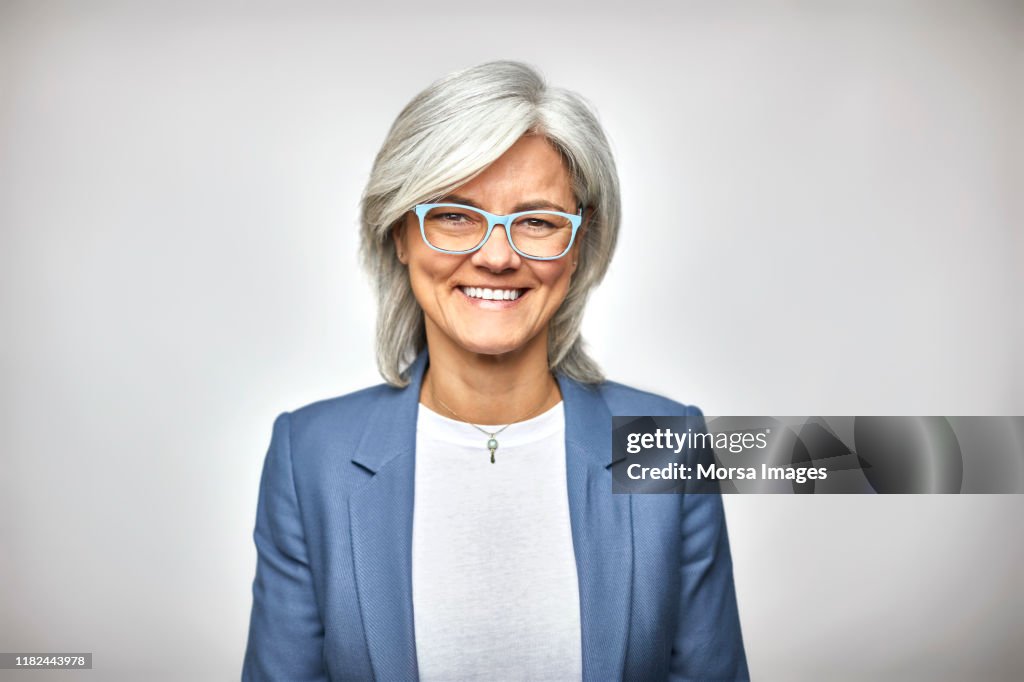 Portrait of smiling senior executive in eyeglasses