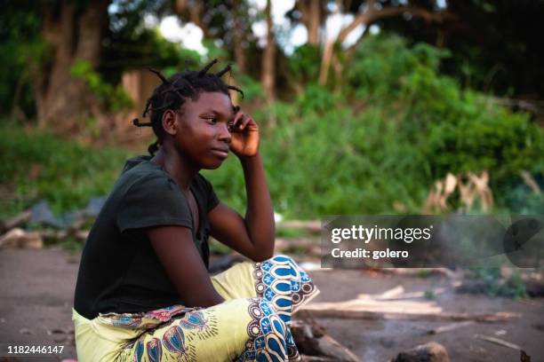 portait of young african woman sitting on the ground - malawi stock pictures, royalty-free photos & images
