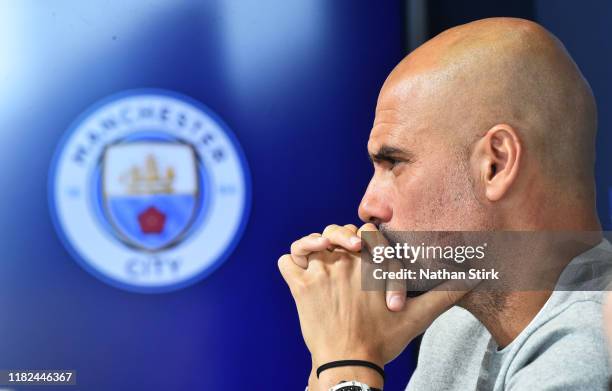 Pep Guardiola, Manager of Manchester City speaks with the media during a Press Conference at The Academy Stadium on October 21, 2019 in Manchester,...