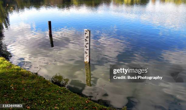 scale indicating water level in a lake - bodenmarkierung stock-fotos und bilder