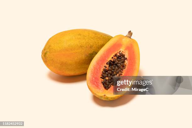 papaya and cross section on colored background - papaye photos et images de collection