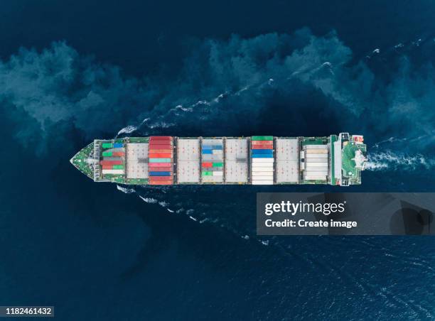 aerial top view container cargo ship carrier container with beautiful wave pattern on the sea for business logistics, import export, shipping or transportation. - shipping container top view - fotografias e filmes do acervo