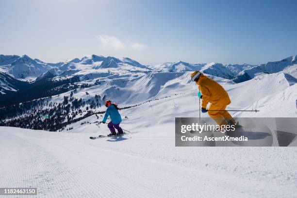 couple enjoying a ski vacation - whistler village stock pictures, royalty-free photos & images