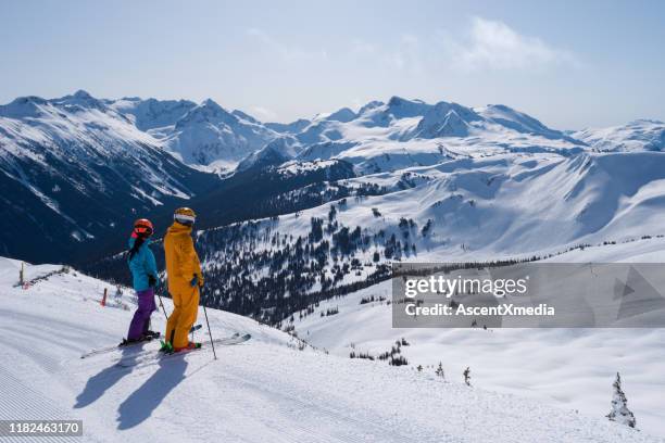 couple enjoying a ski vacation - whistler village stock pictures, royalty-free photos & images