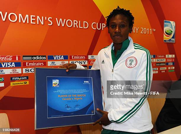 Stella Mbachu of Nigeria holds the Player of the Match award after the FIFA Women's World Cup 2011 Group A match between Canada and Nigeria at Rudolf...