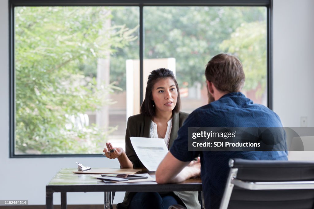 Businesswoman has serious discussion with colleague