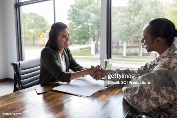 army veteran meets with financial planner - war veteran stock pictures, royalty-free photos & images