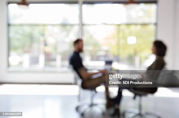 male counselor talks withe female client - hyperopia stock pictures, royalty-free photos & images