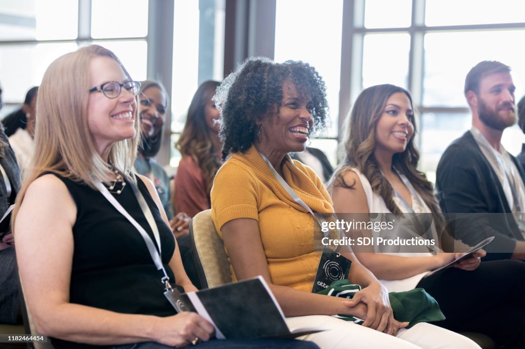 Attentive people smile during conference