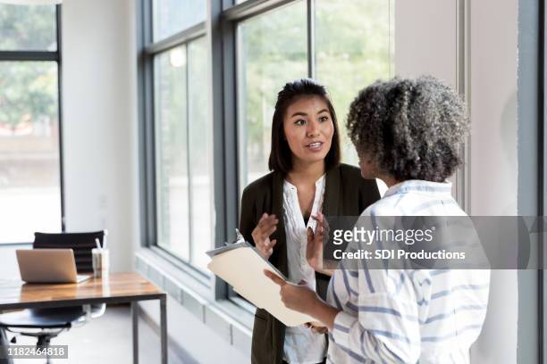 manager and employee discuss staffing issues - discussion stock pictures, royalty-free photos & images