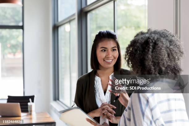 mature manager gives praise to mid adult employee - discussion stock pictures, royalty-free photos & images