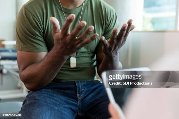 frustrated military patient talking with doctor - alternative therapy stock pictures, royalty-free photos & images