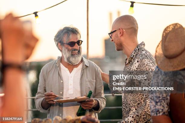 cheerful friends on a summer rooftop event - party in munich stock pictures, royalty-free photos & images