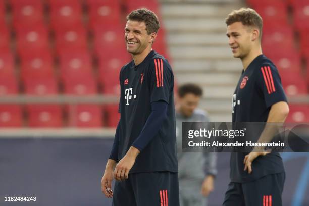 Thomas Müller of FC Bayern Muenchen smiles with his team mate Joshua Kimmich during a training session at Karaiskakis Stadium on October 21, 2019 in...