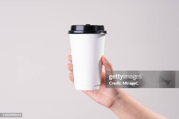 hand holding white paper cup - take away food drink stock pictures, royalty-free photos & images