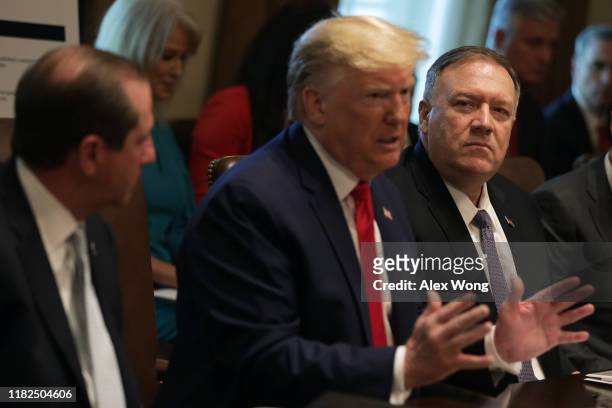 President Donald Trump speaks as Secretary of Health and Human Services Alex Azar and Secretary of State Mike Pompeo listen during a cabinet meeting...