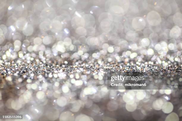 silver glitter background - fall party inside stock-fotos und bilder