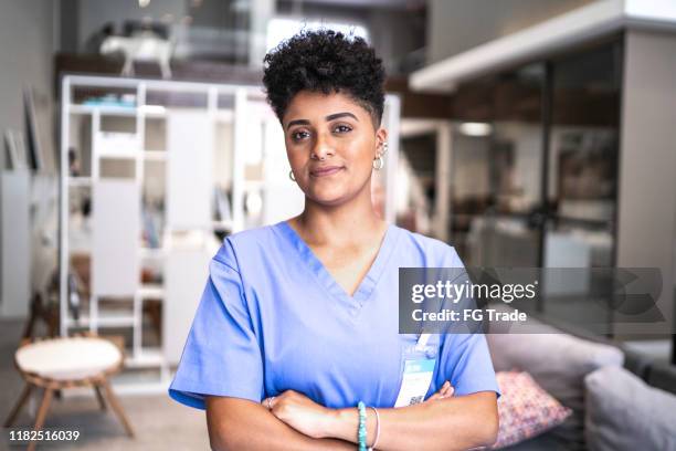 portrait of a serious young nurse/doctor - female nurse stock pictures, royalty-free photos & images