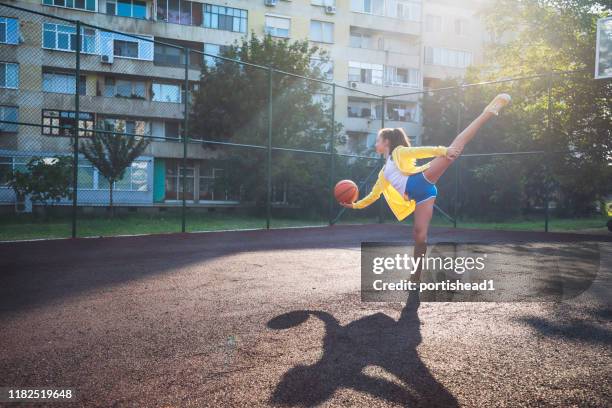 teenager girl practicing ballet with basketball ball - weird hobbies stock pictures, royalty-free photos & images