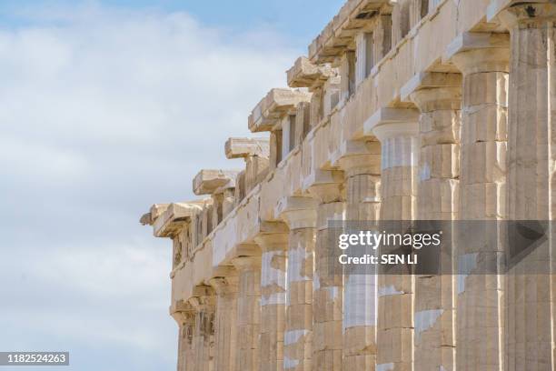 row of columns of the parthenon temple in ancient acropolis - ionisch stock-fotos und bilder