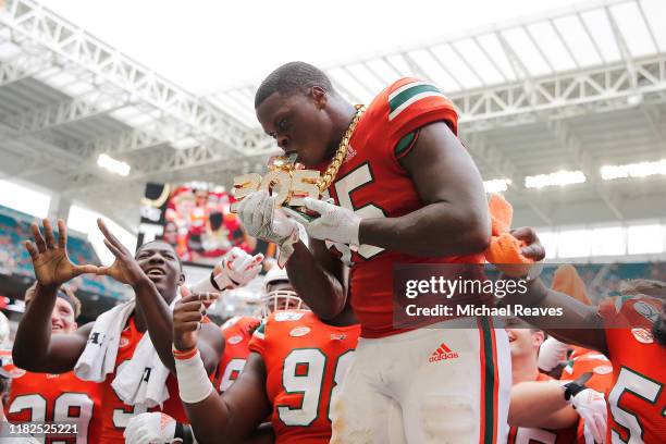 Shaquille Quarterman of the Miami Hurricanes celebrates with the turnover chain against the Georgia Tech Yellow Jackets during the second half at...