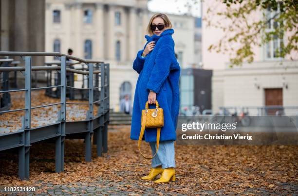 Sonia Lyson is seen wearing yellow mustard boots Dear Frances, Agolde jeans, blue Max Mara teddy coat, Lady Dior bag, Fendi sunglasses on October 21,...