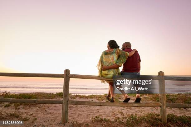 sie genießen panoramablick auf das meer - beach fence stock-fotos und bilder