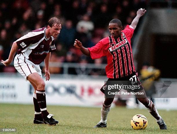 Jermaine Defoe of AFC Bournemouth is watched by James Hunt of Northampton Town during the Nationwide League Division Two match played at the...