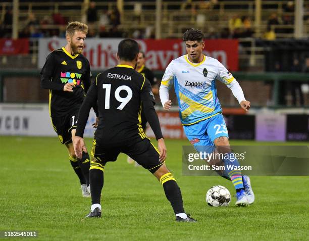 Christian Torres of Las Vegas Lights FC looks to dribble past Christopher Wehan and David Estrada of New Mexico United during the second half of...