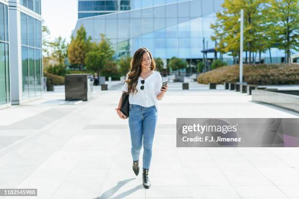 business woman walked while using smartphone. - jeans street style stock pictures, royalty-free photos & images