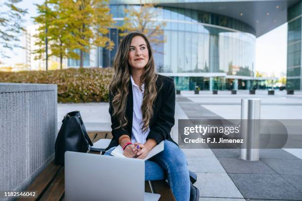 business woman with notebook on her head - business student stock-fotos und bilder