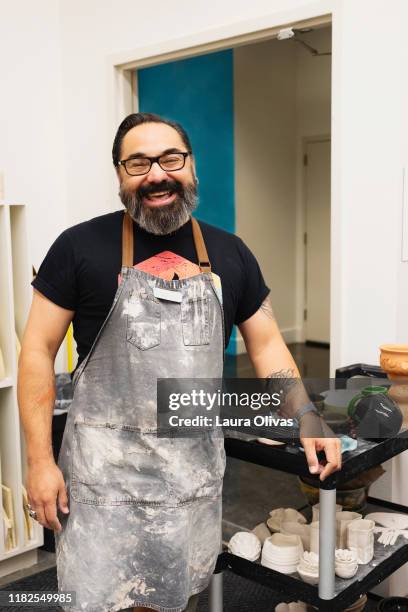 portrait of hispanic male ceramics instructor - generation x ストックフォトと画像