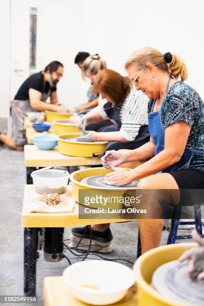 senior women using pottery wheel in class - art and craft stock pictures, royalty-free photos & images
