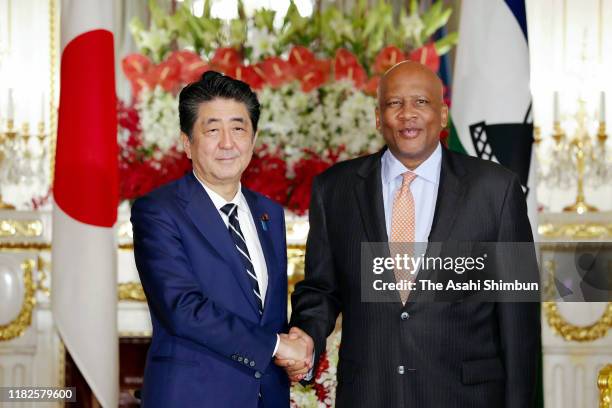 King Letsie III of Lesotho shakes hands with Japanese Prime Minister Shinzo Abe prior to their meeting at the Akasaka State Guest House on October...