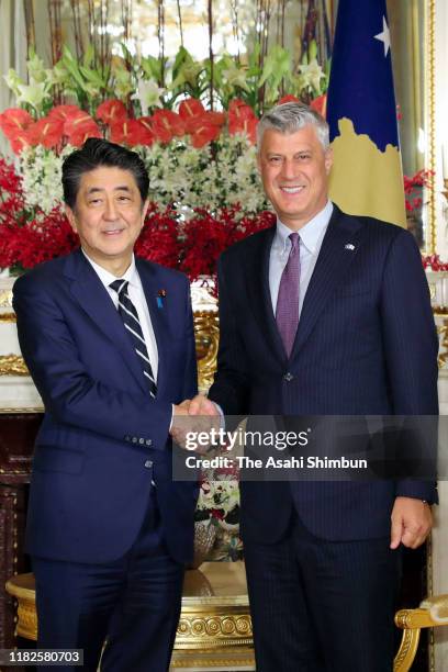 Kosovo President Hashim Thaci shakes hands with Japanese Prime Minister Shinzo Abe prior to their meeting at the Akasaka State Guest House on October...