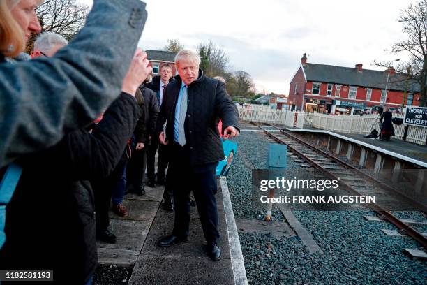 Britain's Prime Minister Boris Johnson gestures during a General Election campaign trail stop at Thornton-Cleveleys railway station in north-west...